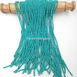 May include: A strand of turquoise blue beads, approximately 200 pieces, on a wooden dowel rod. The beads are small and uniform in size. The text "PaveFindings4u" and "DARK BLUE" are visible on the image.