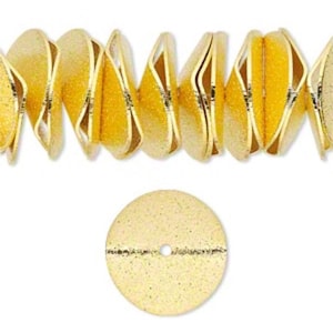 May include: Gold-colored metal sequins with a textured surface. The sequins are round and have a small hole in the center.