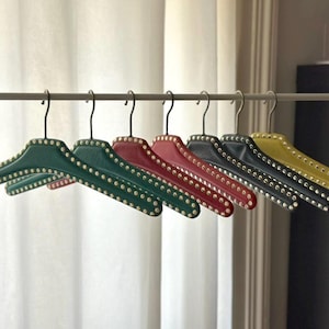 Set of 7 vintage skai hangers with studs. Mid-century. Germany, 1960s