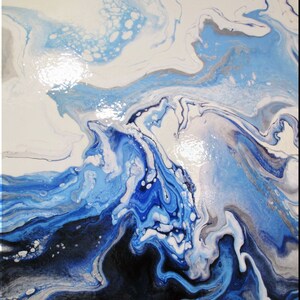 May include: Abstract painting with swirling blue, white, and black paint. The colors blend together to create a dynamic and fluid design.