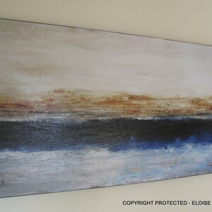 May include: Abstract painting on canvas with a horizontal layered design. The top layer is a light beige with hints of brown. The middle layer is a dark blue with a hint of black. The bottom layer is a light blue with a hint of white.