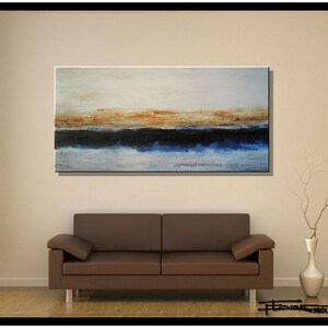 May include: Abstract painting with a horizontal composition. The painting features a blue, black, and brown color scheme. The painting is displayed on a wall above a brown leather sofa.