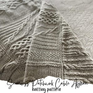 May include: A close-up of a beige knitted blanket with a cable stitch pattern. The blanket is folded in half, showing the intricate details of the design. The text "Seamless Patchwork Cable Afghan knitting pattern" is visible at the bottom of the image.