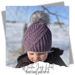May include: Purple knitted hat with a white pom pom. The hat has a diagonal pattern and is made with a soft yarn. Winter Joy Hat knitting pattern.