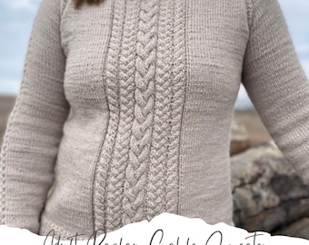 May include: A beige knitted sweater with a cable knit pattern. The sweater has a raglan sleeve and a high neckline. The text "Adult Raglan Cable Sweater knitting pattern" is written on the bottom of the image.