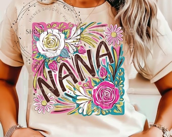 May include: A white t-shirt with a floral design and the word "NANA" in black lettering. The flowers are pink, yellow, and green.