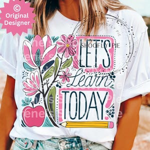 May include: White t-shirt featuring a floral design and the text "Let's Learn Today!" in colourful lettering. A yellow pencil is also included in the design.