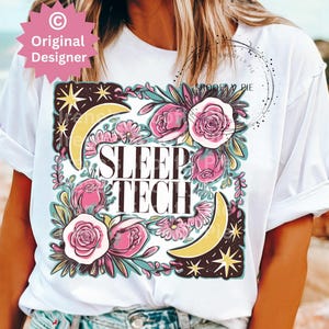 May include: White t-shirt with a floral design and the text "SLEEP TECH" in black lettering. The design features pink flowers, yellow moons, and stars.