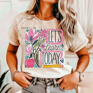 May include: A beige t-shirt with a floral design and the text "Let's Learn Today".