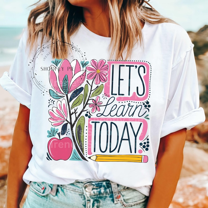 May include: White t-shirt with a pink and green floral design and the text "Let's learn today".