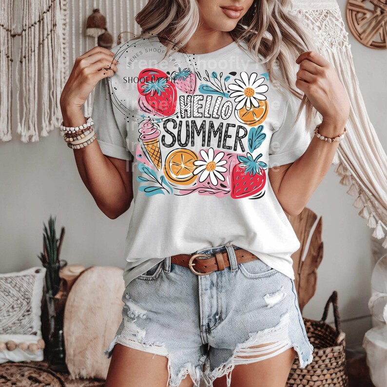 May include: A white t-shirt with a colorful graphic design featuring the text "Hello Summer" surrounded by strawberries, lemons, ice cream cones, and daisies.
