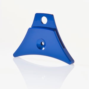 May include: A blue metal whistle with a rounded, triangular shape. It has two holes on the top and one on the side.