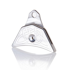 May include: A silver whistle with a Celtic knot design. The whistle has a small hole on the top for attaching a lanyard.