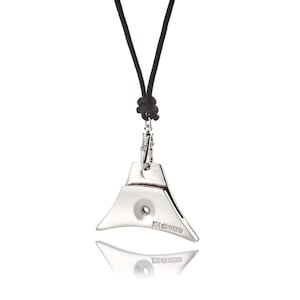 May include: A silver whistle pendant necklace with a black leather cord. The whistle is triangular in shape with a round hole in the center. The back of the whistle is engraved with the text "925 STERLING".