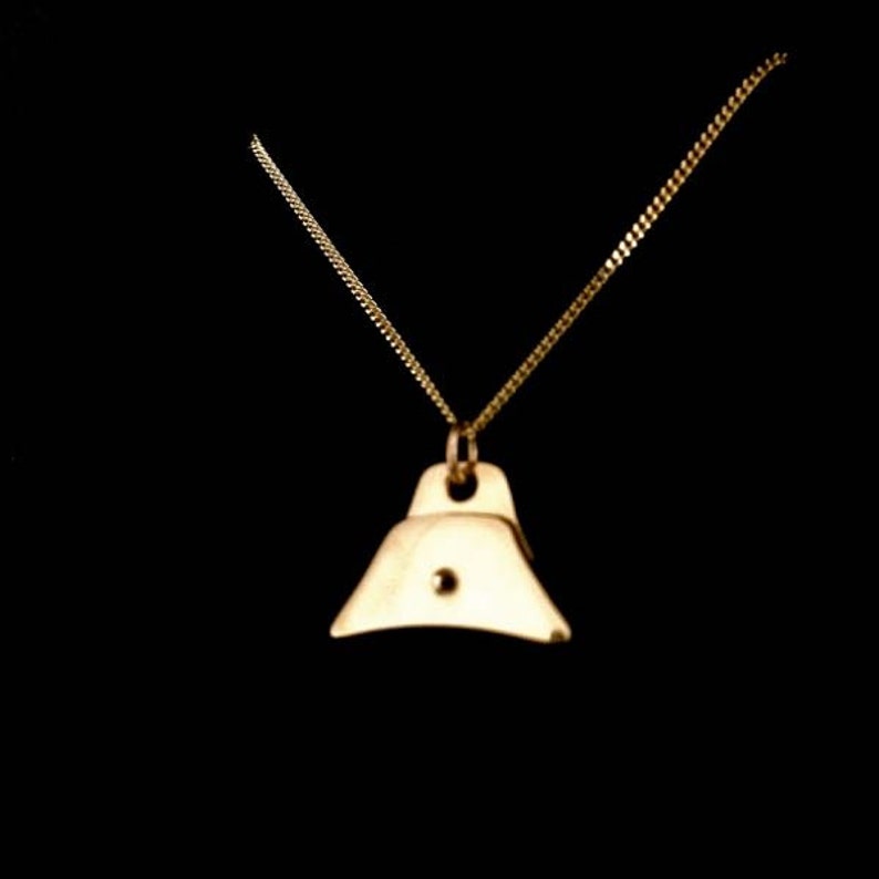 May include: A gold chain necklace with a gold whistle pendant.