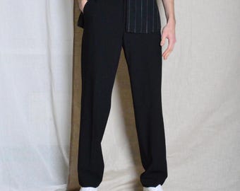 May include: Black dress pants with a straight leg fit. The pants have a zipper fly and button closure. The pants are made of a smooth, wrinkle-resistant fabric.