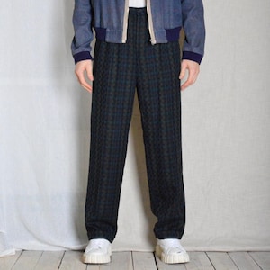May include: A pair of black and green plaid pants with a straight leg fit. The pants have a high waist and a button closure.