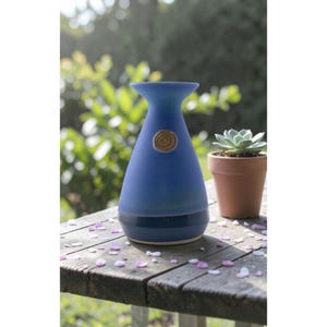 May include: A set of three ceramic mugs with a speckled, matte finish. The mugs are in shades of cream, light gray, and dark gray. Each mug has a simple, minimalist design, perfect for coffee or tea.