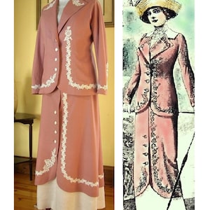 May include: A dusty rose two-piece suit consisting of a long-sleeved jacket and a floor-length skirt. The jacket features a white collar, white buttons, and white floral embroidery along the lapels and hem. The skirt has a white underskirt.