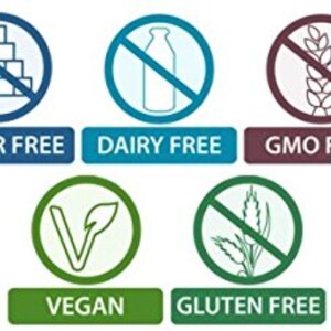 May include: A collection of six icons indicating dietary information. The icons include "Sugar Free," "Dairy Free," "GMO Free," "Vegan," and "Gluten Free." Each icon features a symbol inside a circle with a line through it, and a corresponding text label below.