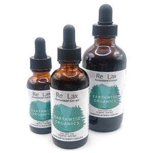 May include: Three amber glass bottles of organic extract with black droppers. The labels read "Re Lax Formulated Extract" and "Earthwise Organics." Sizes include 1 oz, 2 oz, and 4 oz. Handmade in North Carolina.