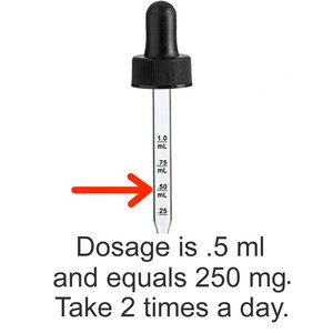 May include: A clear glass dropper with black rubber bulb and a black screw-on cap. The dropper has graduated markings in milliliters, with the text "Dosage is .5 ml and equals 250 mg. Take 2 times a day."