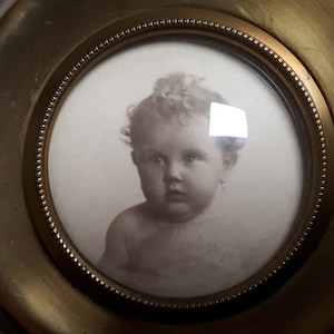 Antique brass photo frame, round, curved glass, stand, little legs, French circa 1900