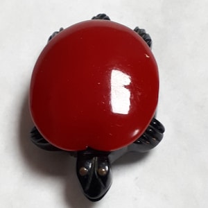 BAKELITE turtle dress clip, VINTAGE, red and black, detailed carving