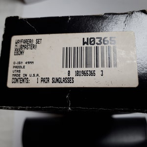 May include: Black cardboard box with a label that reads "WAYFARER SET CLUBMASTER EBONY." The label also includes "0-159 49MM" and "1 PAIR SUNGLASSES." The box has a barcode and the text "MADE IN U.S.A."