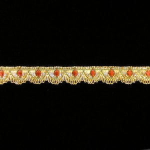 May include: Gold trim with red accents. This trim features a scalloped edge and is perfect for adding a touch of elegance to any project.