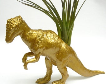Золотой динозавр. Динозаврик золотой. Есть золотой Динозаврик. Золотые монеты с динозаврами.