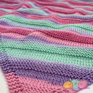 May include: A knitted blanket with stripes of pink, purple, and green.