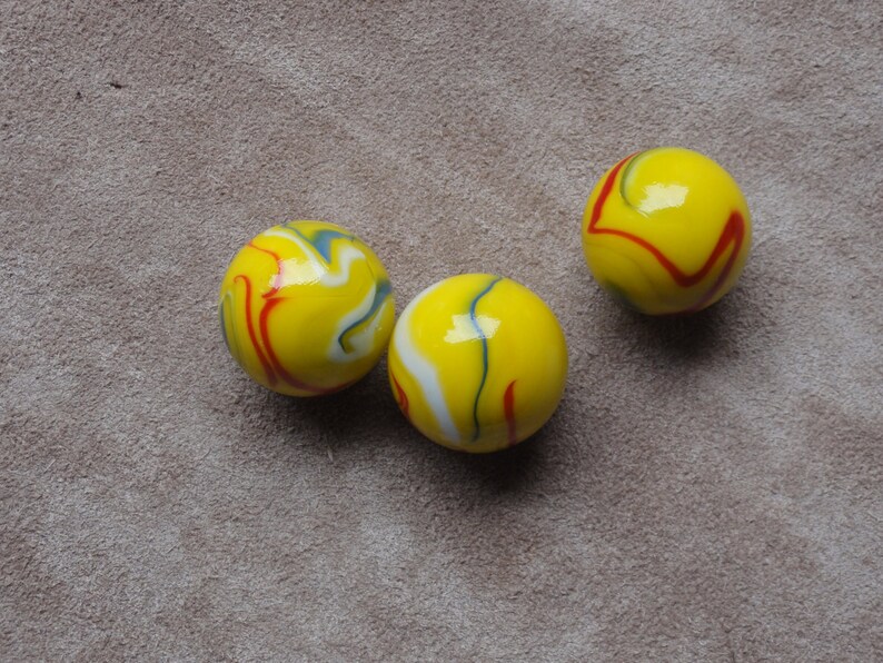 Glass Marble yellow with blue red and white streaks Etsy