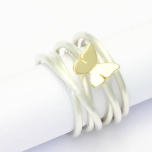 Coiled ring silver with butterfly of yellow gold