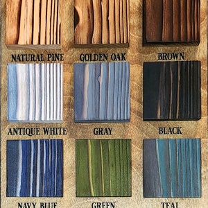 May include: A wooden sign with the text "MAD ARTIST STUDIOS" and "AVAILABLE COLORS" above a grid of 12 wood samples in different colors. The colors are: Natural Pine, Golden Oak, Brown, Antique White, Gray, Black, Navy Blue, Green, Teal, Red, Orange, and Yellow.