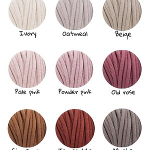 May include: Nine balls of yarn in various colors, including ivory, oatmeal, beige, pale pink, powder pink, old rose, cinnamon, terracotta, and mocha.