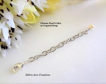 May include: Silver chain extender with a lobster clasp on one end and a small pearl on the other. Choose Pearl Color or Crystal Drop.