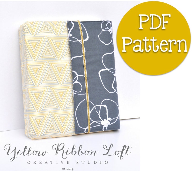 May include: A PDF pattern for a book cover with a gray fabric with white abstract shapes and a yellow fabric with a geometric pattern of triangles. The pattern is titled "PDF Pattern" in a yellow circle.