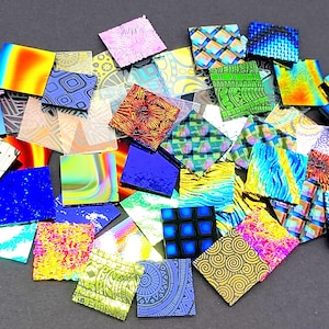 May include: A collection of colorful, patterned glass tiles. The tiles are square and have a variety of designs, including geometric patterns, floral motifs, and abstract designs. The tiles are perfect for use in mosaic art projects.