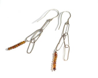 Earrings. Faceted roundel carnelian beads hang from sterling silver handmade links.