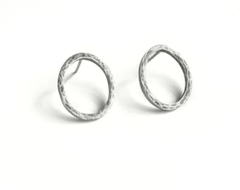 Handmade sterling silver hoop earrings with textured organic design