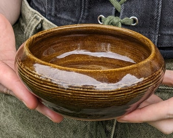 Small handmade ceramic bowl in earthy glossy celadon brown. A shallow dish!