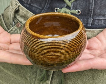 Small handmade ceramic bowl in earthy glossy celadon brown. A stout dish!