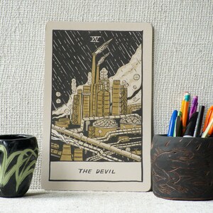 The Devil Tarot Card, showing a liquefied natural gas factory spewing pollution into the air.