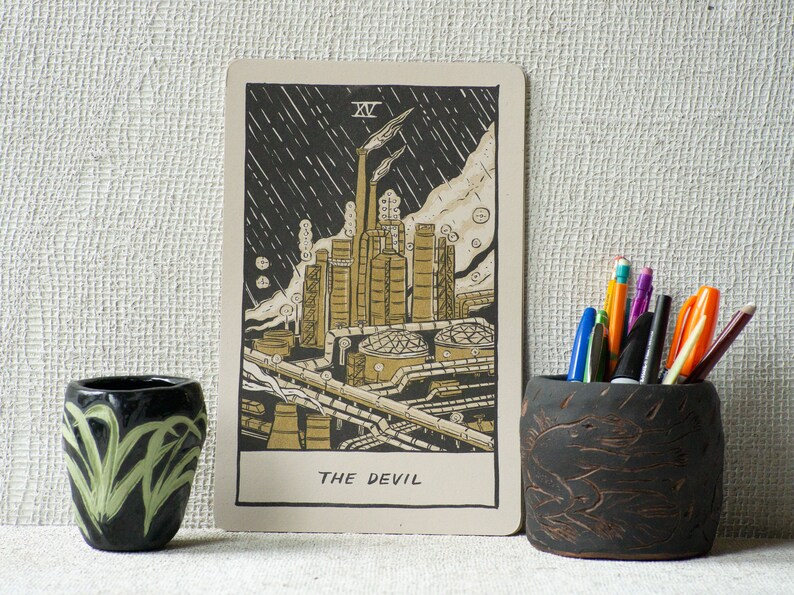 The Devil Tarot Card, showing a liquefied natural gas factory spewing pollution into the air.