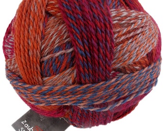 May include: A ball of red, orange, blue, and gray yarn with a label that reads "Zauberball Stärke 6".