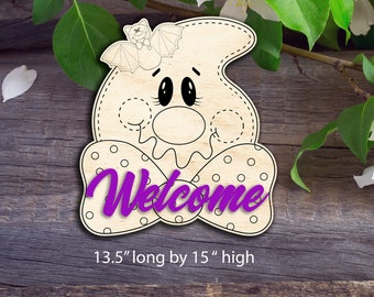May include: Wooden Halloween ghost decoration with a bat on top. The ghost has a polka-dot bow tie and the word "Welcome" in purple. The sign is 13.5 inches long and 15 inches high.