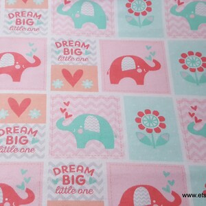 May include: Pink and green fabric with a repeating pattern of elephants, flowers, and the text "Dream Big Little One".