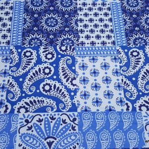 May include: Blue and white paisley patterned fabric with a patchwork design. The fabric features various paisley patterns and geometric designs.
