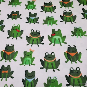 May include: A white fabric with a repeating pattern of green frogs. The frogs are in various poses, some wearing accessories like necklaces, glasses, and bandanas.